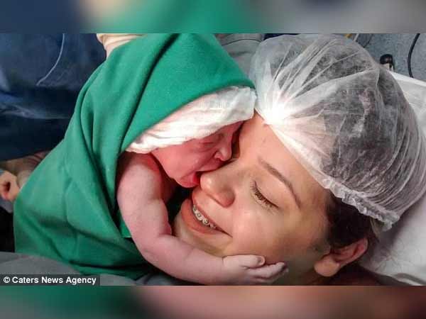 Touching moment baby hugs her mother seconds after being born Touching moment baby hugs her mother seconds after being born
