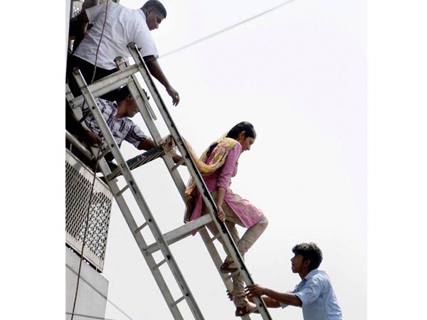 Fire personnel rescuing a girl