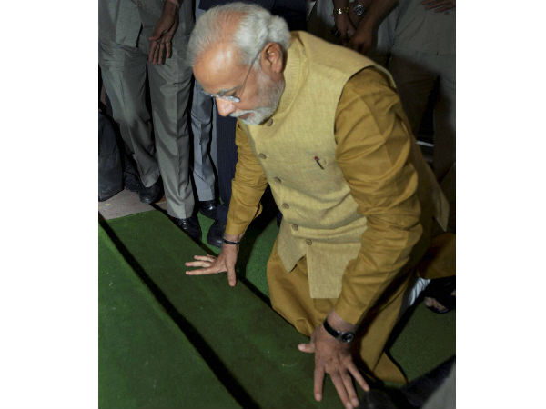 Modi touches his forehead to the ground in respect before entering the parliament Modi touches his forehead to the ground in respect before entering the parliament