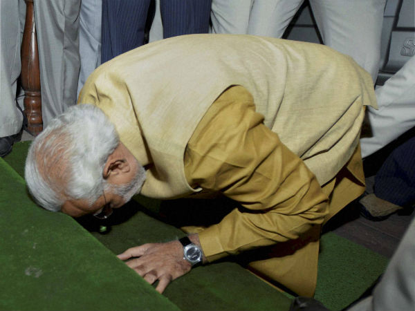 Modi touches his forehead to the ground in respect before entering the parliament Modi touches his forehead to the ground in respect before entering the parliament