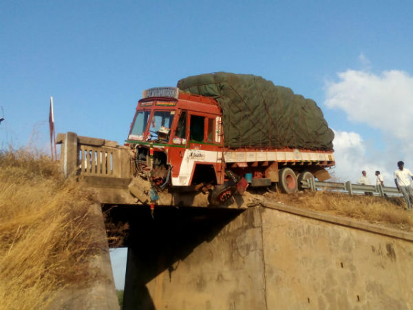 Lorry hangs from birdge after met with accident Lorry hangs from birdge after met with accident