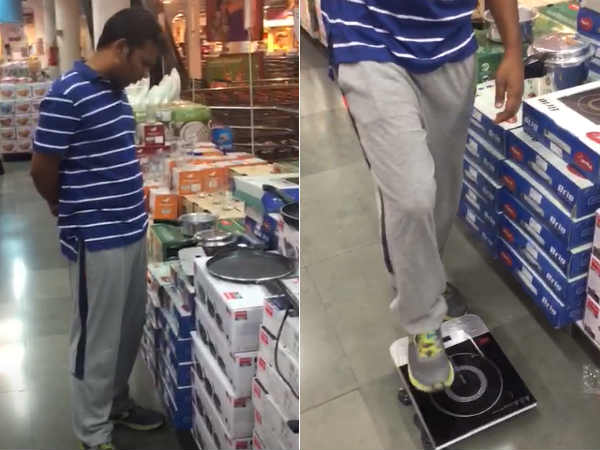 A man going to stand up and check his weight in induction stove A man going to stand up and check his weight in induction stove