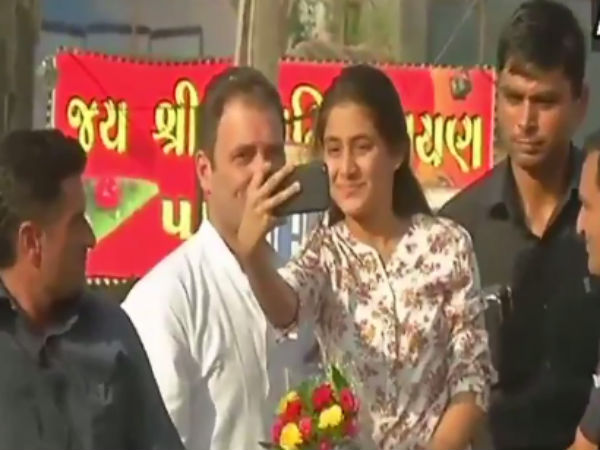A Young girl gets on to Congress Leader Rahul Gandhi's vehicle in a roadshow A Young girl gets on to Congress Leader Rahul Gandhi's vehicle in a roadshow