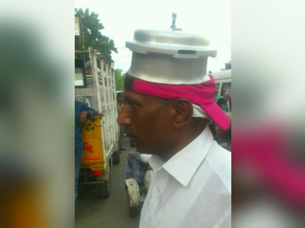 A supporter of TTV Dinakaran campaigns with both of cap and cooker A supporter of TTV Dinakaran campaigns with both of cap and cooker