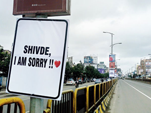 A young Business Man stakes flex banner for his girlfriend in main road as I am sorry A young Business Man stakes flex banner for his girlfriend in main road as I am sorry