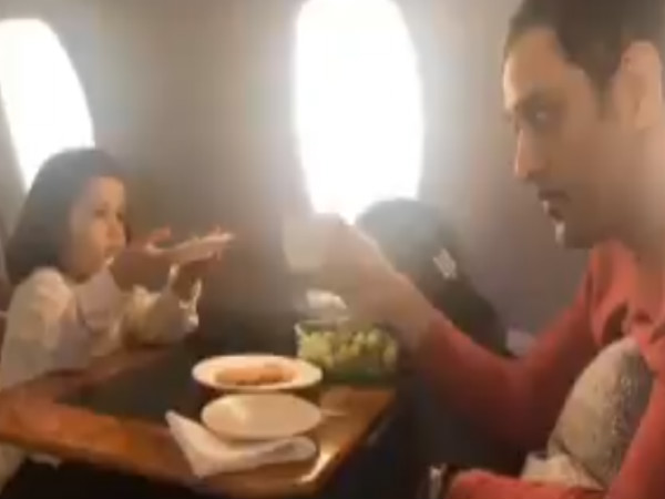 MS Dhoni plays with his daughter Ziva on flight MS Dhoni plays with his daughter Ziva on flight