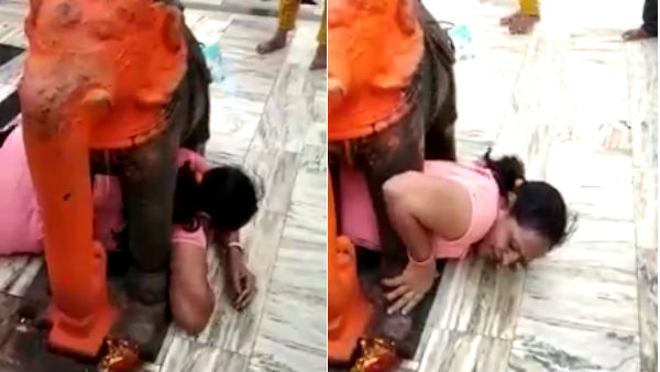Viral video woman gets stuck under Elephant statue Viral video woman gets stuck under Elephant statue