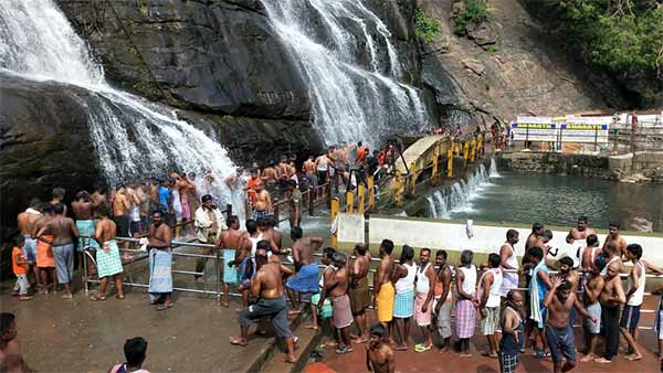 Moderate water being poured courtallam waterfalls Moderate water being poured courtallam waterfalls