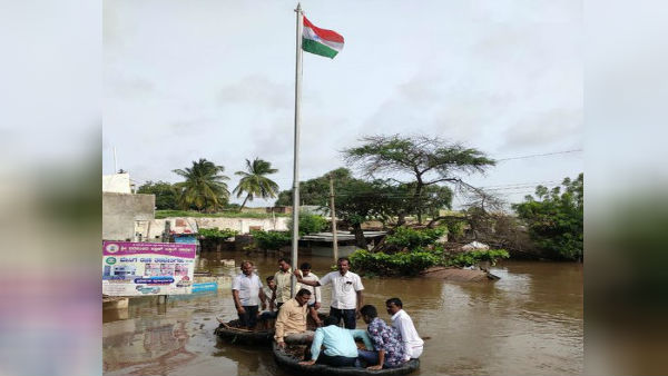 People in Karnataka hoist National Flag in immersed flood water People in Karnataka hoist National Flag in immersed flood water