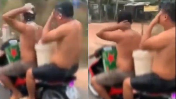 two vietnam men bathe fined for bathing while riding motorbike two vietnam men bathe fined for bathing while riding motorbike