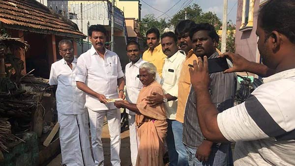 anbil mahesh mla helped the elderly woman by giving his own money anbil mahesh mla helped the elderly woman by giving his own money
