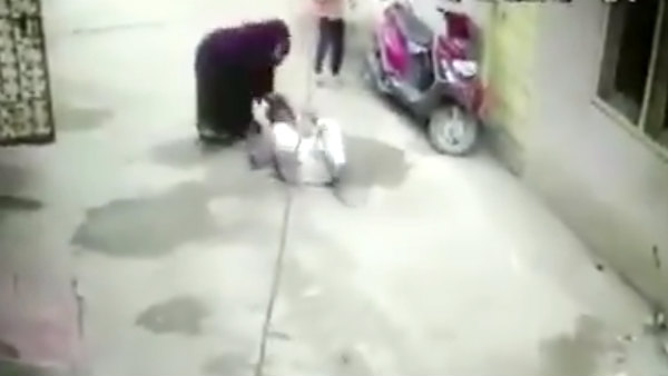 A woman being thrashed by her daughter-in-law and her mother in Hyderabad A woman being thrashed by her daughter-in-law and her mother in Hyderabad