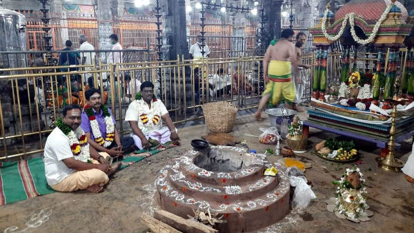 Thiruvannamalai: Praying Pooja at the top of the hill sprinkling of holy water Thiruvannamalai: Praying Pooja at the top of the hill sprinkling of holy water