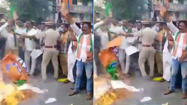 BJP workers accidentally burn their own party flag BJP workers accidentally burn their own party flag