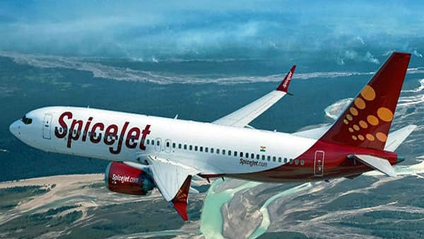 Passenger onboard SpiceJet flight tries to open emergency exit mid-air Passenger onboard SpiceJet flight tries to open emergency exit mid-air