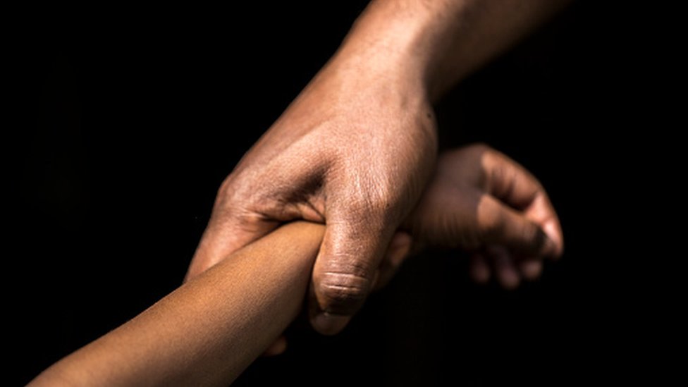 An adult holding a childs hand An adult holding a childs hand