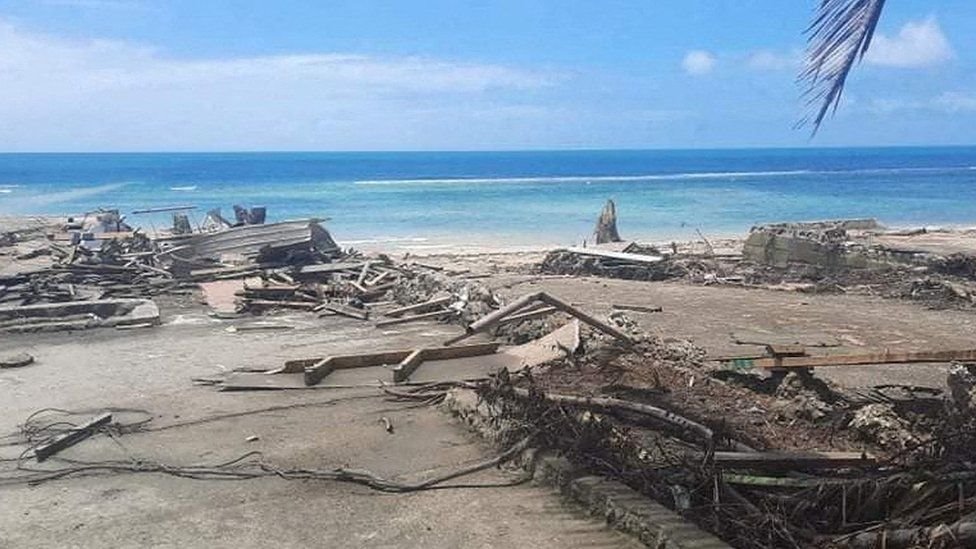 Debris litters the beach in Nukualofa, Tonga, after the tsunami - near Atata island where Mr Folau was